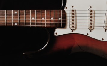 Zbliżenie na elektryczną gitarę solową na ciemnym tle